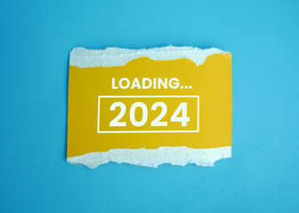 2024 New Year Loading. Loading bar with wooden blocks 2024 on blue background. Start the new year 2024 with a goal plan, goal concept, action plan, strategy, and new year business vision.