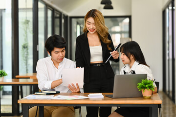 Millennial woman business team leader explaining project information to colleague