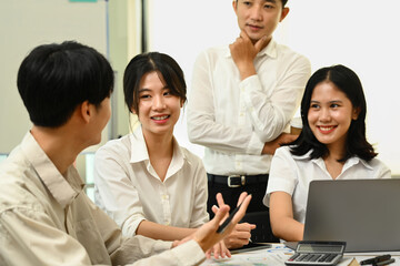 Economist team analyzing financial market reports, discussing information at meeting