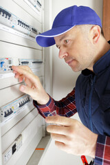 an electrician assembling power switchboard