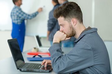 electrical engineer looking at computer during class