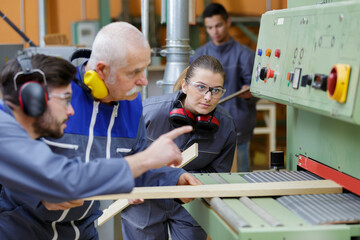 engineers at wood cutting machine