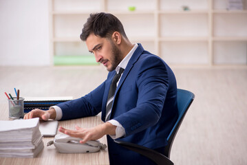 Young male employee working in the office