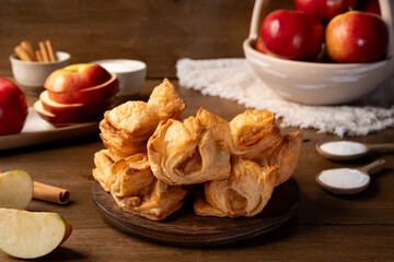Puff pastry with apple on a wooden background. Mini pies. Delicious dessert. Breakfast.
