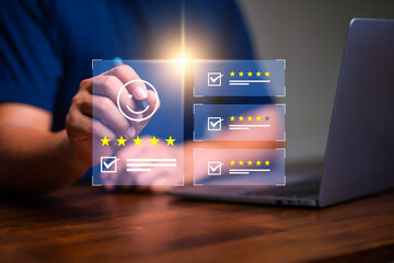 Customer rating and satisfaction concept, Man using laptop and touch virtual screen for give five star symbol to increase rating of product and service concept.
