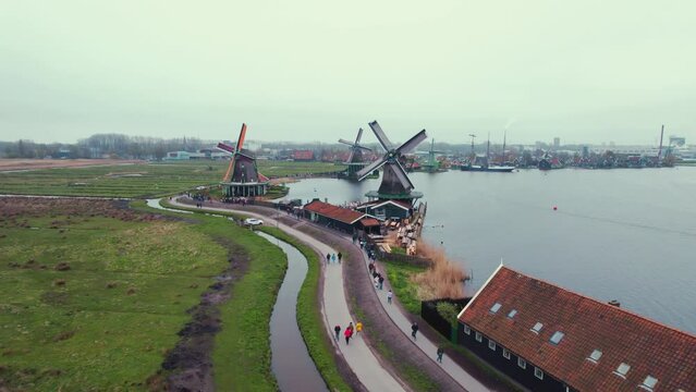 Drone flying over Zaanse Schans windmills museum and the river Zaan, Netherlands. High quality 4k footage