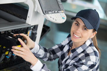 woman maintaining an office photocopier