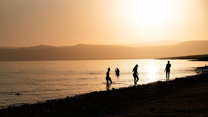 Fototapeta premium silhouettes against sunset at dead sea in jordan