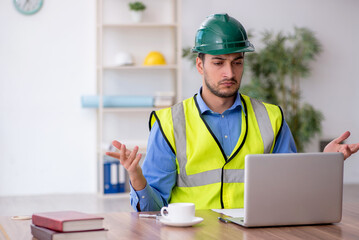 Young male architect working in the office