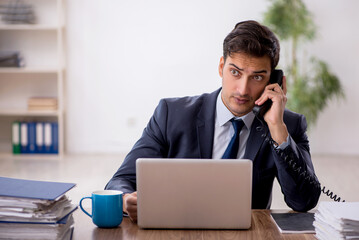 Young male employee working in the office