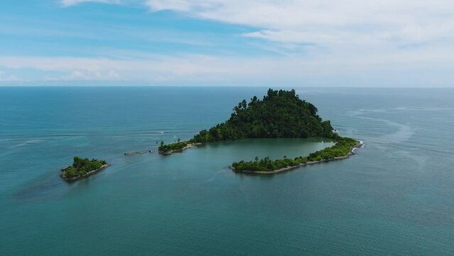 Air survey of Tropical island with a beach in the open ocean. Cabugao Island. Mindanao, Philippines.