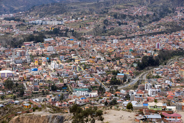 View from the scenic road to the landmark Muela del Diablo over the highest administrative capital, the city La Paz and El Alto in Bolivia - close up of hundreds of houses