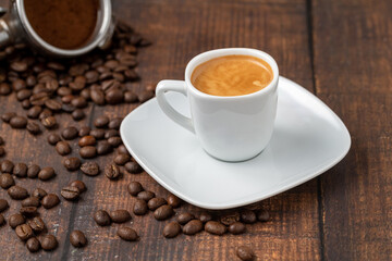 Fresh espresso coffee together decorated with coffee beans on wooden table