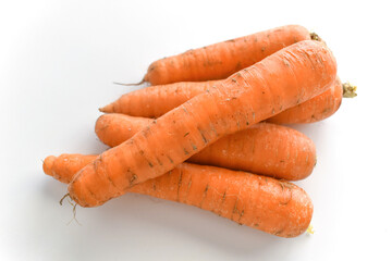 Raw carrots on white table. 