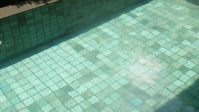 abstract texture background view of swimming pool water surface in swimming pool with sunlight shining in summer holiday vacation time