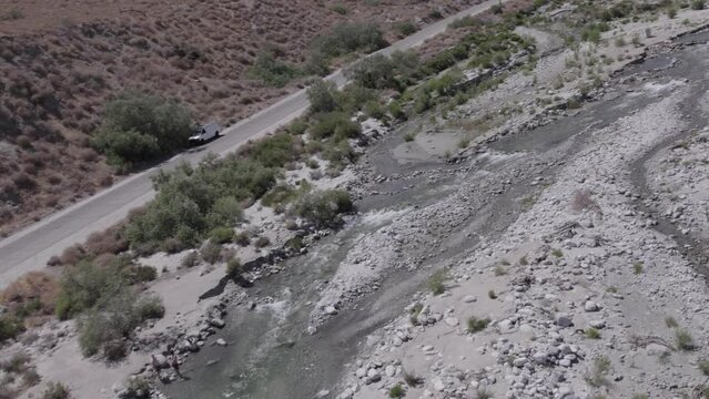 aerial view of running water in desert oasis 