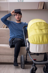 Young male contractor looking after baby at home