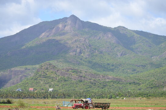 Nature of the mountain, field work by using tracter ,shadow of the clouds, village, forest