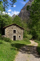 Fototapeta na wymiar Typical stone barn of Picos de Europa to spend the winter with the livestock. Leon, Spain