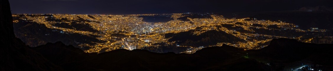City lights of La Paz and El Alto, highest capital and vibrant city surrounded by the highest peaks of the Andes mountains in Bolivia, South America - Panorama