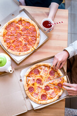 Top view of two friends students meeting and eating pizza together.Soft focus, 6 October 2022. Russia. High quality photo