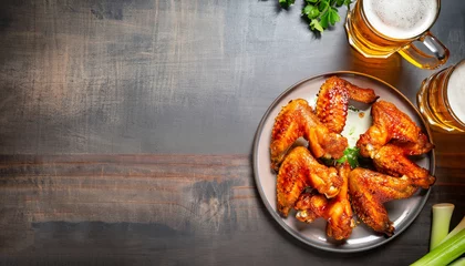  Buffalo style chicken wings served with cold beer, top view with copy space © Uuganbayar