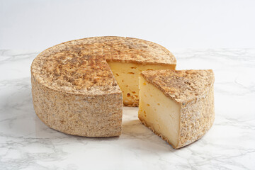 Alt Urgel cured cheese, Catalonia, Spain. beautiful Spanish cheeses arranged on light rustic wood, selective focus.