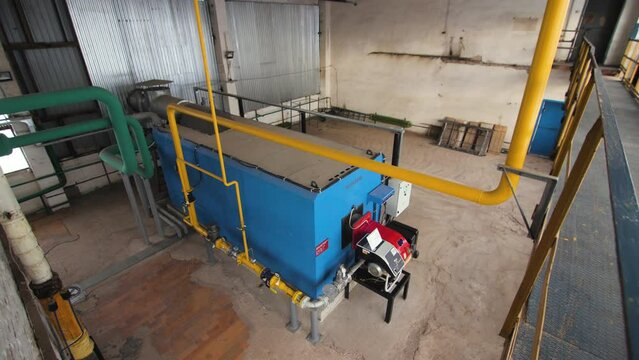 Hydraulic boiler system for hot water supply with pipes and valves. Yellow pipes and valves in boilers for water transportation at production plants