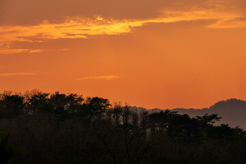 The view of the natural background of the mountain close-up, with blurred fog scattered in the rainy season or the humid climate, with beautiful green trees in the ecological system