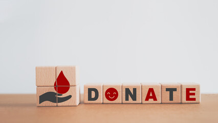 Blood donation concept. red blood over grey hand icon with donate word, smiling face instead of O,...