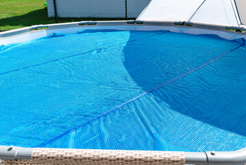 A large expansion pool with a diameter of 3.96 m, set in the yard next to the house, covered with a...