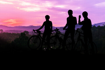 Fototapeta premium A silhouette of a cyclist on a mountain bike riding in a dramati