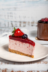 Types of cakes. Cheesecake and cream cake on wood background. Close up