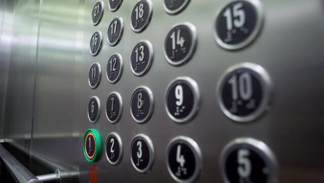 Close-up of a female hand pressing an elevator button in a business center or residential building. High quality 4k footage