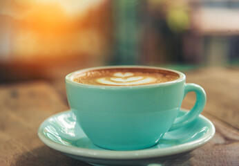 Latte art coffee cup with milk on wooden table. Espresso shot make latte art hot coffee cup. Cappuccino with milk in italian coffee shop cafe. Brown hot caffeine beverage in cafeteria with copy space