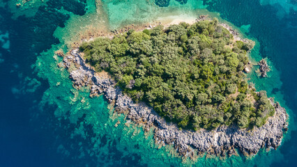 Aerial shooting of islands and cliffs. Aerial drone photo. Aerial top view of tropical island surrounded by turquoise sea. Aerial drone photo