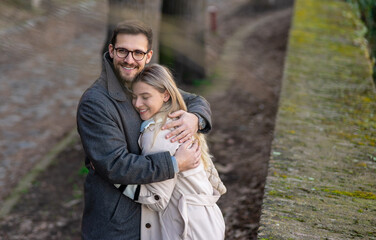 Fototapeta premium Happy young couple hugging and laughing outdoors.