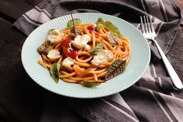 Salad caprese or pasta spaghetti with basil and mozzarella