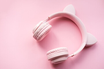 Pink headphones with cat ears on a pink background with copy space. music girl concept