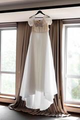 Fototapeta na wymiar light and elegant bride's dress on a mannequin in a chic luxury interior