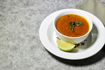 traditional bowl of spiced algerian vegetable soup named (Harira)