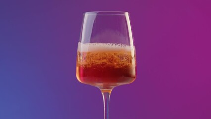 Hand of a professional bartender pours prosecco from bottle into long drink glass with aperol. Preparation of a summer cocktail aperol on the bar with neon lighting and blue purple background