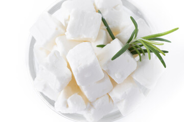 Feta cheese, cucumber and herbs in a bowl isolated on white background. Close up