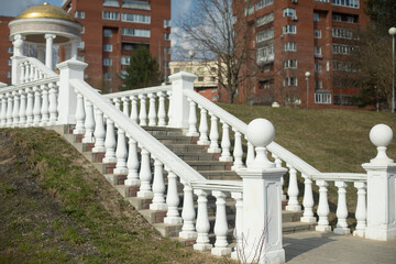 White staircase in park. Old staircase in city. Classical architecture in park.