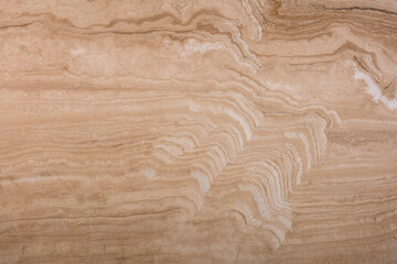 Unique texture of natural travertine, soft pattern of beige and brown wavy layers