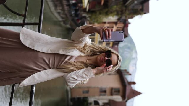 Beautiful Woman Model Tourist Taking Selfie Photo in Annecy, France - Vertical