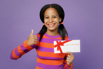 Little kid teen girl of African American ethnicity 15 years old wear orange sweatshirt hold store...