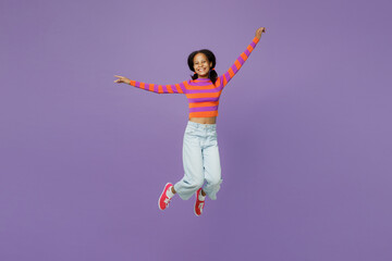 Fototapeta na wymiar Full body excited happy little kid teen girl 15-16 years old wear striped orange sweatshirt jump high with outstretched hands pov fly isolated on plain purple background. Childhood lifestyle concept.