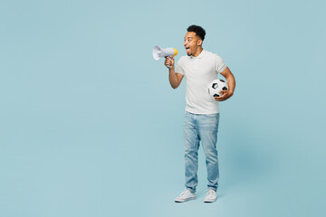 Full body side view young man fan wears t-shirt cheer up support football sport team hold in hand...