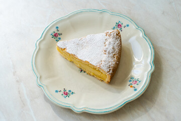 A piece of Custard cream cake with pine nuts. Traditional italian cake - torta della nonna or grandmother's cake. Tuscany pastry.